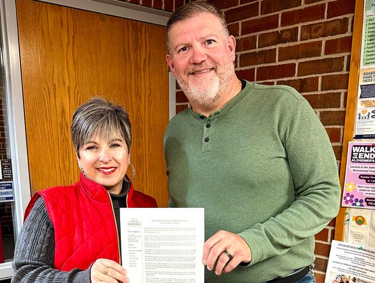 Showing off the proclamation for Small Business Season 2025 is Leslie Clark, Executive Director of the Auburn Chamber and Auburn Mayor Chris Erickson.