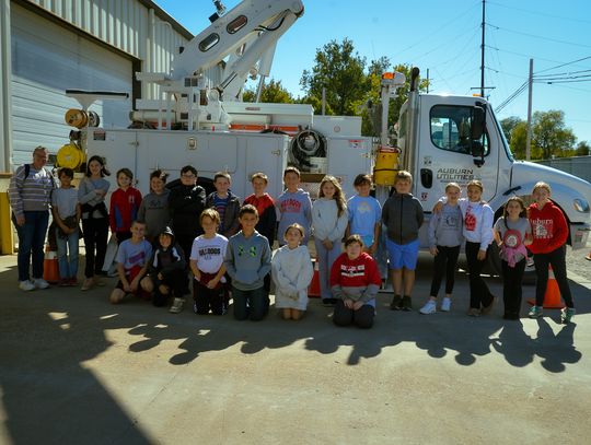 Mrs Dunn's fourth grade class pose in front of a BPW truck