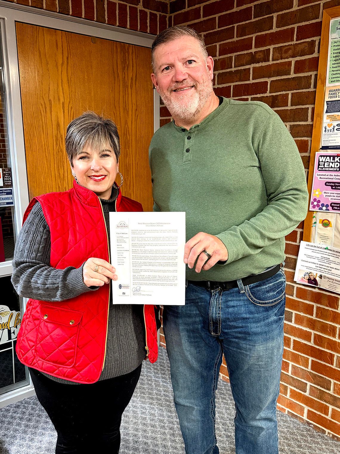 Showing off the proclamation for Small Business Season 2025 is Leslie Clark, Executive Director of the Auburn Chamber and Auburn Mayor Chris Erickson.