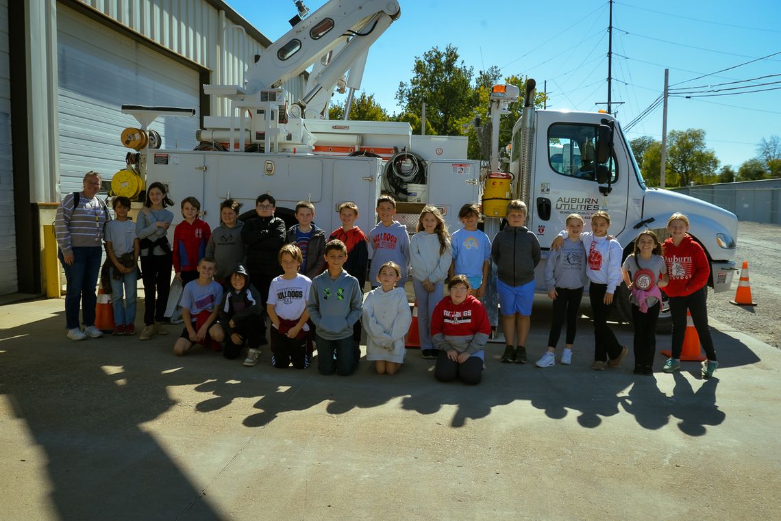 Mrs Dunn's fourth grade class pose in front of a BPW truck
